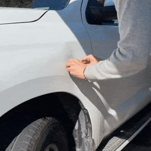 guy uses Cumuul Car Dent Puller on white car